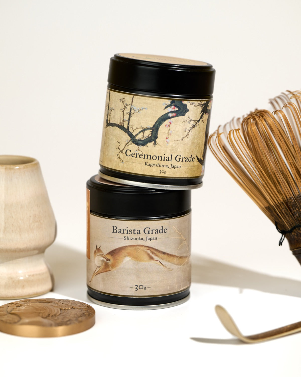 matcha nova ceremonial and barista matcha tins with a bamboo whisk